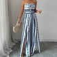 👗 50% OFF NOW! 💥 Geometric Jumpsuit with Halter Neckline & Side Slit – Unique print & elastic back – Versatile, perfect for summer parties or resort wear ✨